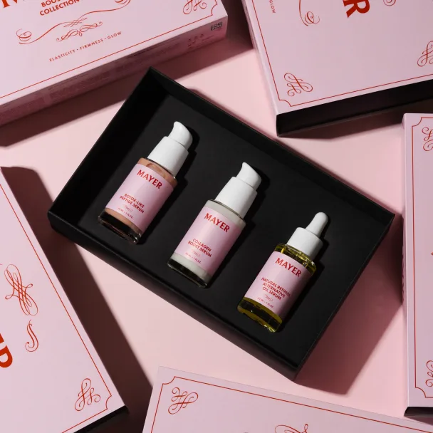 Rosafarbene Geschenkbox mit drei Tropfflaschen in rosa gebrandeter Verpackung.